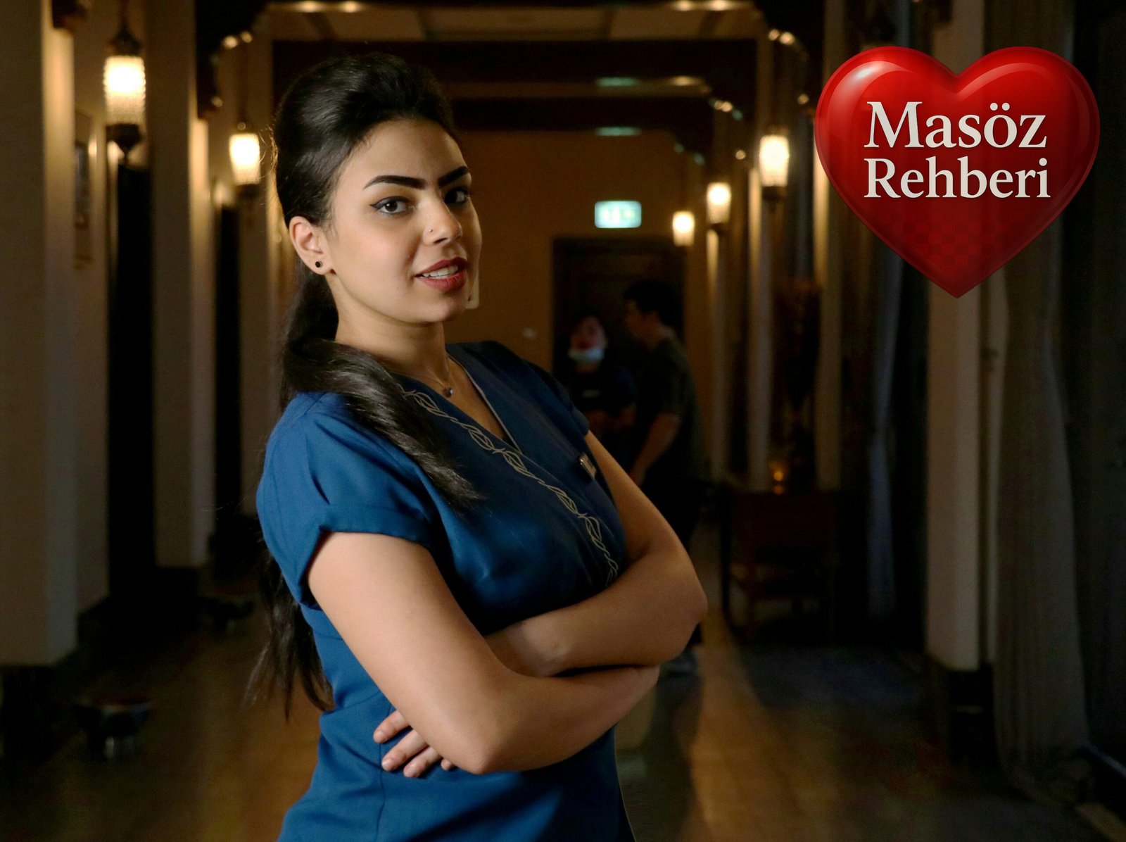 woman in blue shirt standing on hallway
